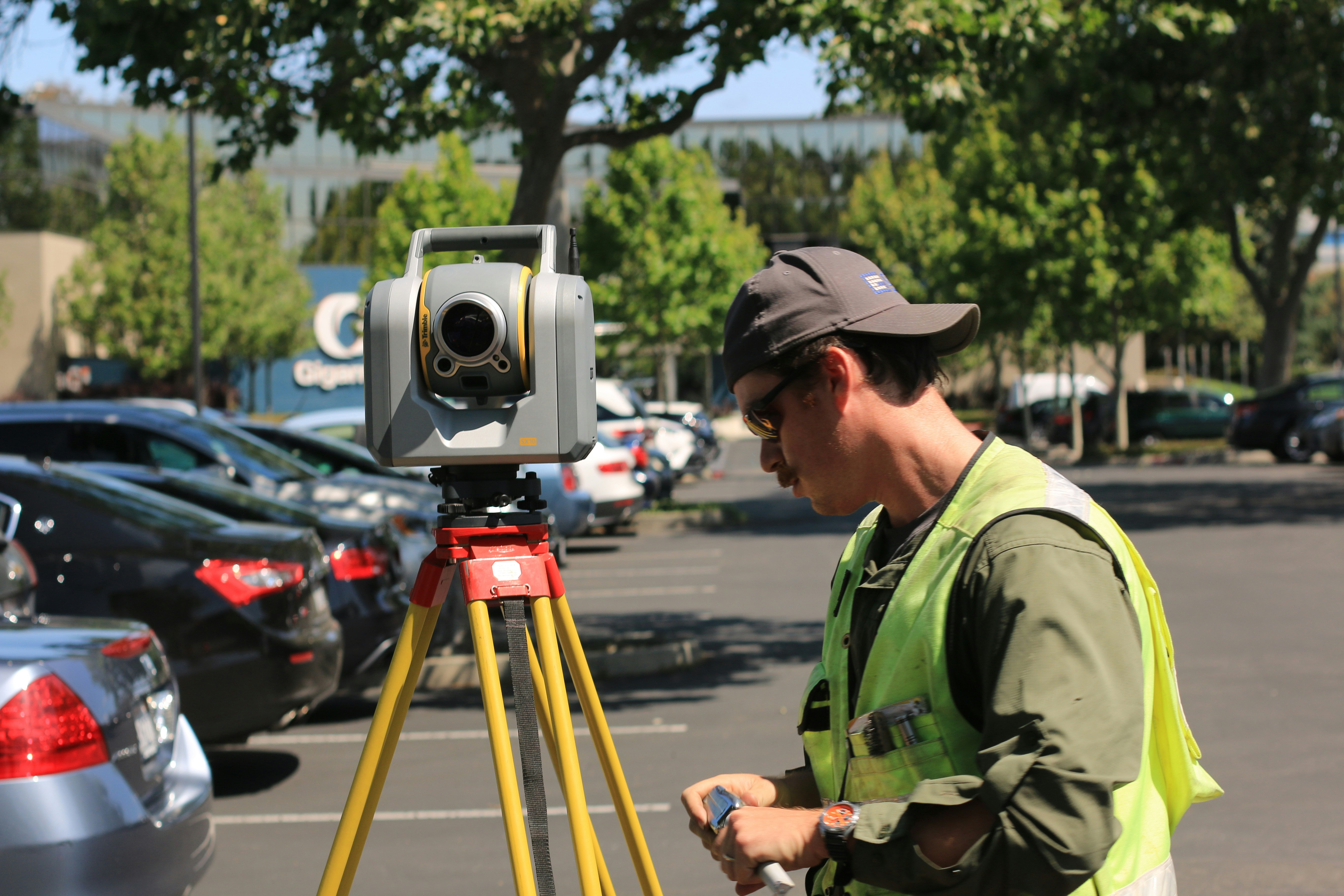Engineer using a CCTV drainage survey tool to inspect underground pipes on a construction site